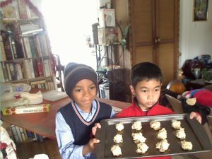 Leo (in red) and Mateo holding the White Chocolate Cheey cookies