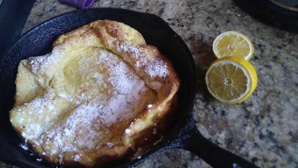 Dutch Baby with powdered sugar and lemon