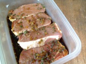 Pork chops marinating in an Asian sauce