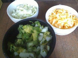 Topping for tacos - chopped avocado, cilantro and onion; chopped cabbage, shredded cheese