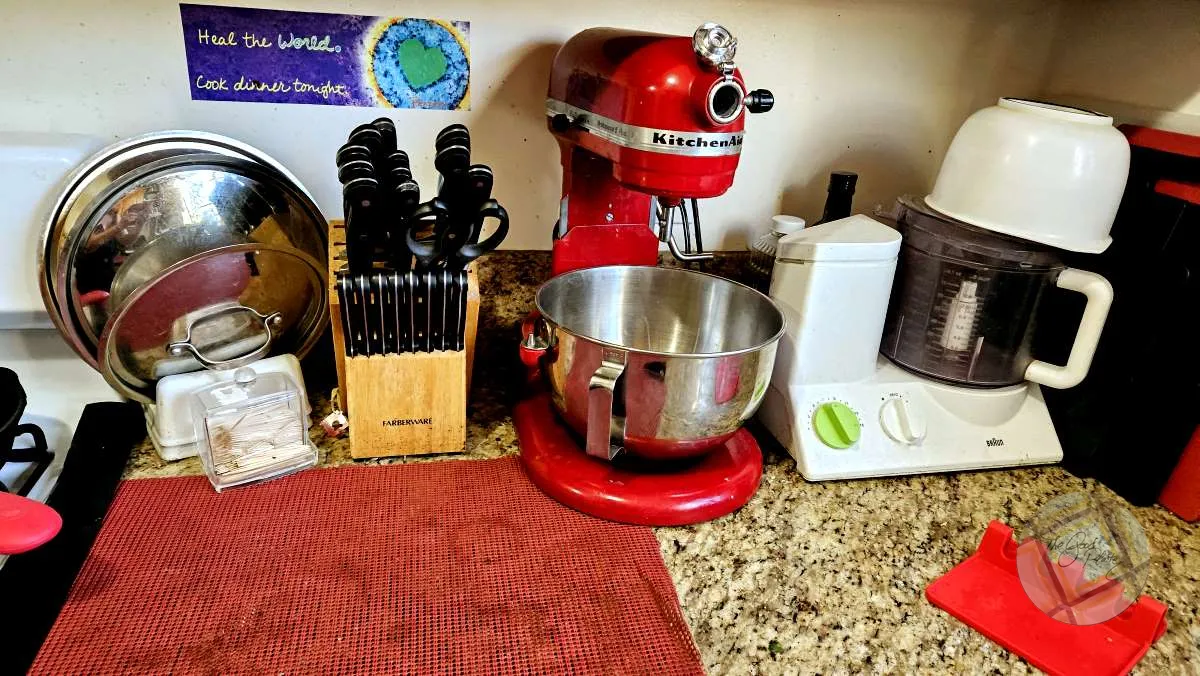 Tiny kitchen Prep area with my KitchenAid mixer and my Braun food processor, plus a plethora of cutting boards.